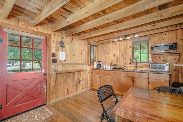 a view of a hallway with entryway and wooden floor