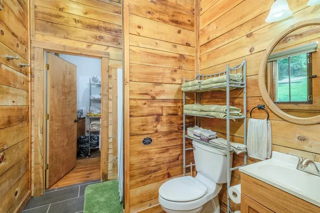 a view of a chair and tables in the patio next to a yard