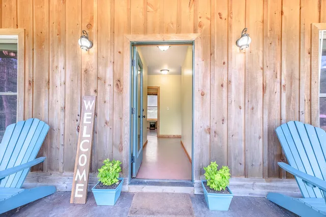 a view of a patio with a table and chairs and potted plants