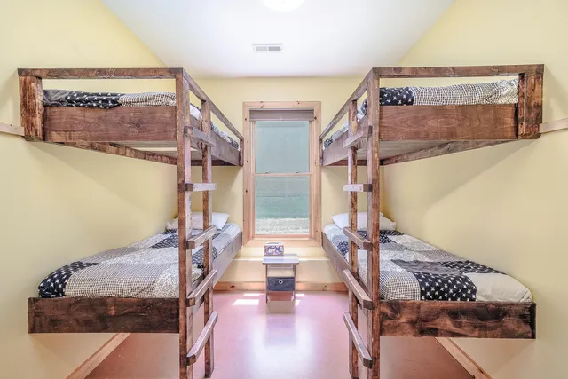 a backyard of a house with barbeque oven table and chairs