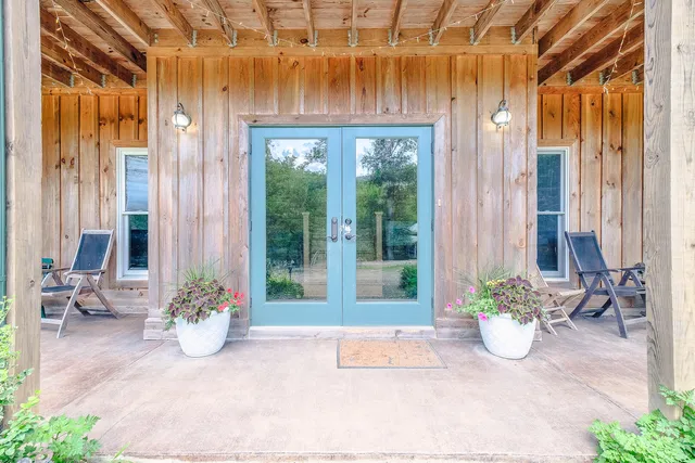 a view of a lush green forest with trees and some houses