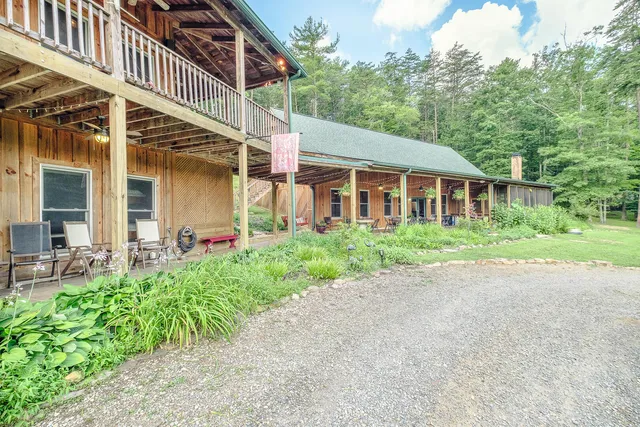a view of a patio with a table and chairs and potted plants