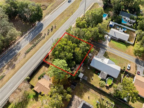 an aerial view of a residential houses with yard