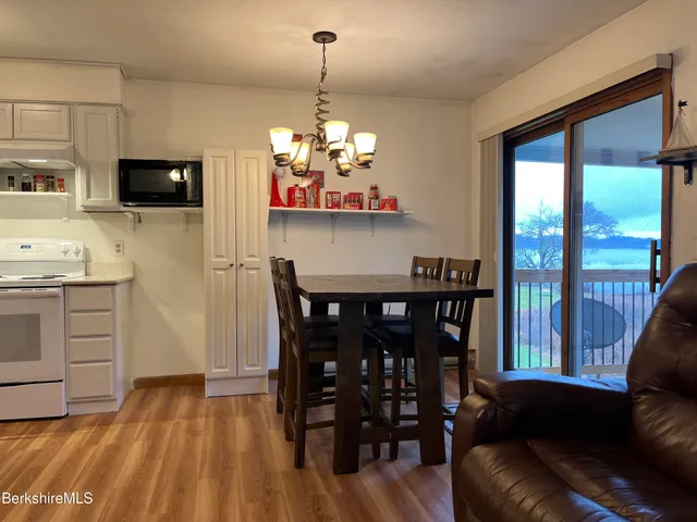 a living room with lots of furniture and kitchen view
