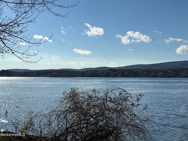 a bedroom with a bed and a mirror