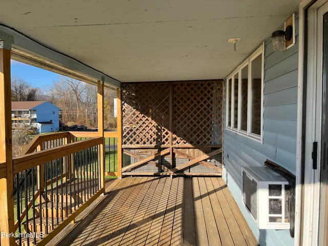 a kitchen with stainless steel appliances granite countertop a refrigerator a sink dishwasher a stove with white cabinets and wooden floor