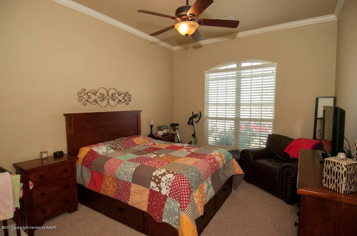 3807 Arden Road Amarillo, TX 79118 - Photo 11 of 26 a bedroom with a bed dresser and a window