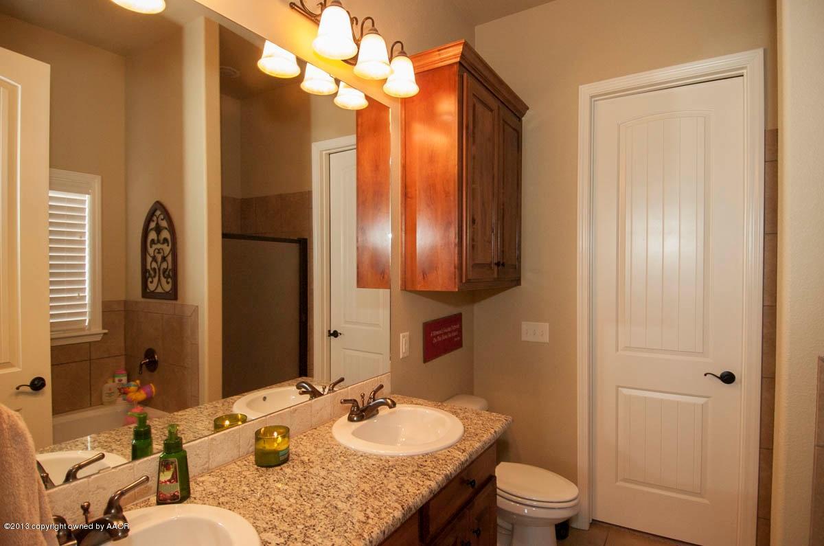 3807 Arden Road Amarillo, TX 79118 - Photo 13 of 26 a bathroom with a granite countertop sink toilet and shower