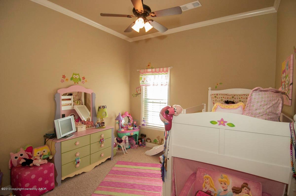 3807 Arden Road Amarillo, TX 79118 - Photo 16 of 26 a bedroom with a bed and a chandelier