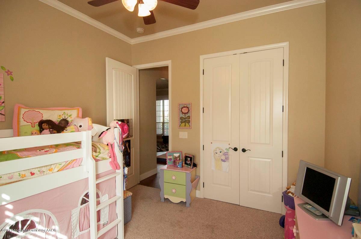 3807 Arden Road Amarillo, TX 79118 - Photo 17 of 26 a bedroom with a bed and a chandelier