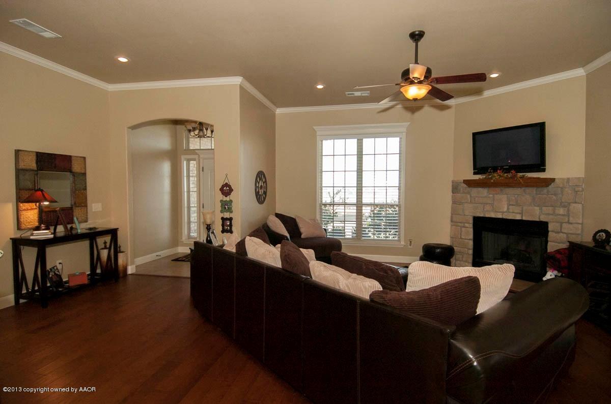 3807 Arden Road Amarillo, TX 79118 - Photo 3 of 26 a living room with furniture a fireplace and a flat screen tv