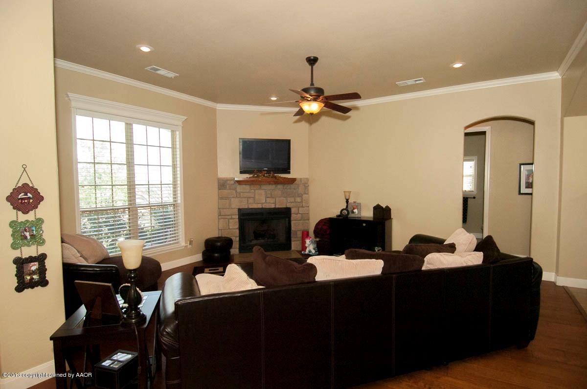 3807 Arden Road Amarillo, TX 79118 - Photo 4 of 26 a living room with furniture a fireplace and a flat screen tv