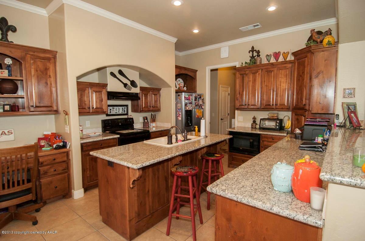 3807 Arden Road Amarillo, TX 79118 - Photo 5 of 26 a kitchen with stainless steel appliances granite countertop a sink counter space and a stove top oven