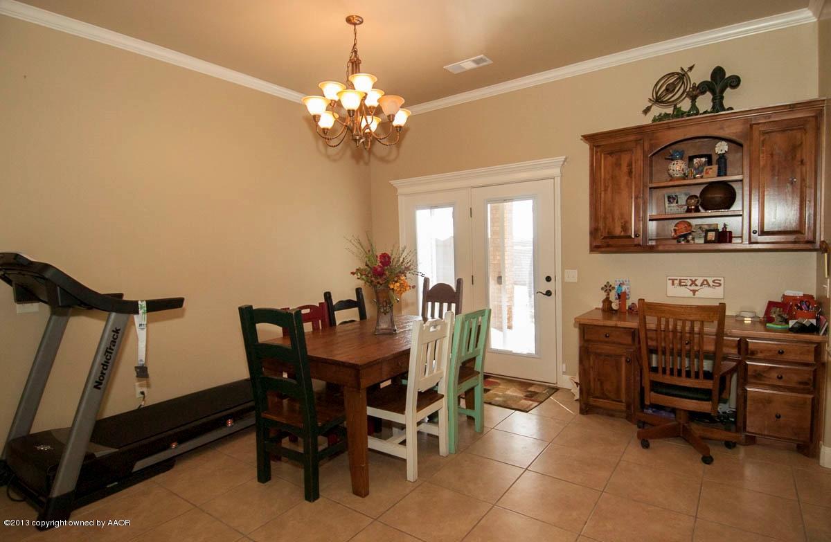 3807 Arden Road Amarillo, TX 79118 - Photo 10 of 26 a view of a dining room with furniture and a chandelier