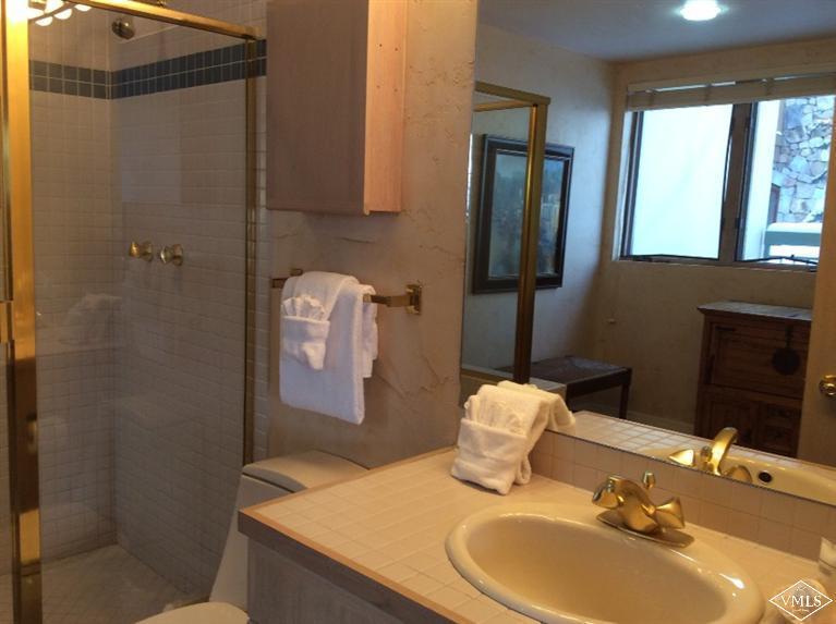 12 Vail Road, Unit R4 Vail, CO 81657 - Photo 11 of 23 a bathroom with a sink vanity granite and a mirror