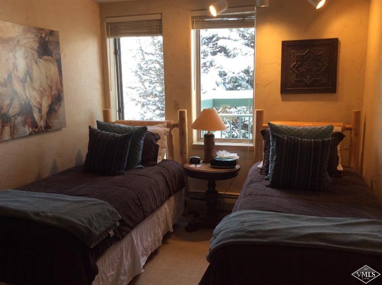 12 Vail Road, Unit R4 Vail, CO 81657 - Photo 14 of 23 a bedroom with a bed and a couch