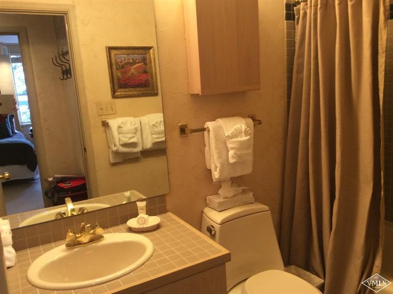 12 Vail Road, Unit R4 Vail, CO 81657 - Photo 15 of 23 a bathroom with a sink mirror vanity and toilet