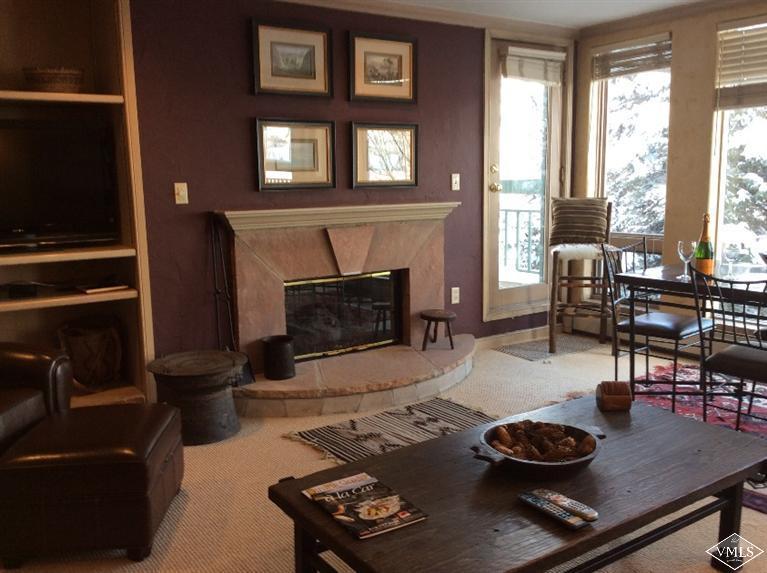 12 Vail Road, Unit R4 Vail, CO 81657 - Photo 3 of 23 a living room with furniture and a fireplace