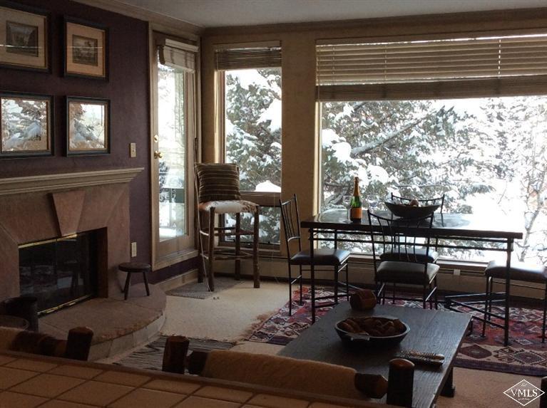 12 Vail Road, Unit R4 Vail, CO 81657 - Photo 4 of 23 a living room with furniture and a floor to ceiling window