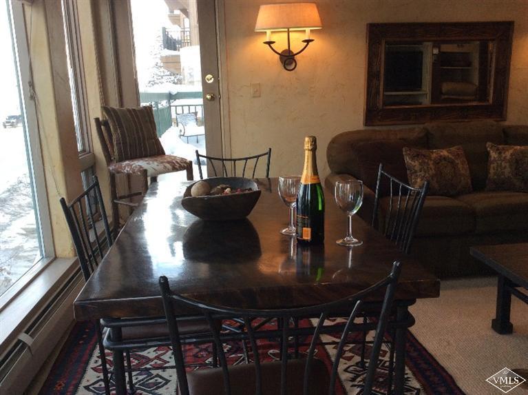 12 Vail Road, Unit R4 Vail, CO 81657 - Photo 5 of 23 a view of a dining room with furniture and wooden floor