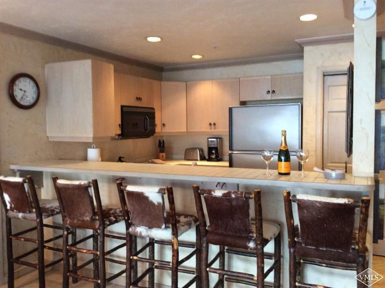 12 Vail Road, Unit R4 Vail, CO 81657 - Photo 6 of 23 a large kitchen with a table and chairs