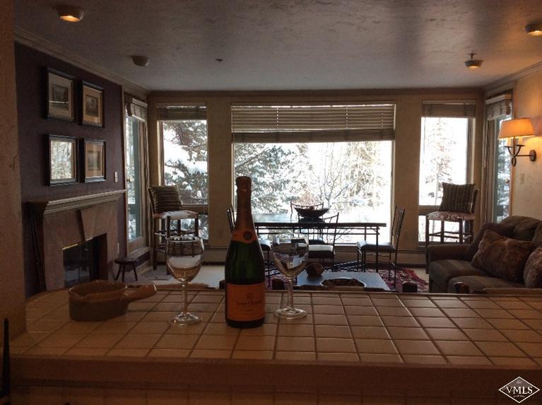 12 Vail Road, Unit R4 Vail, CO 81657 - Photo 8 of 23 a living room with furniture large window and flat screen tv