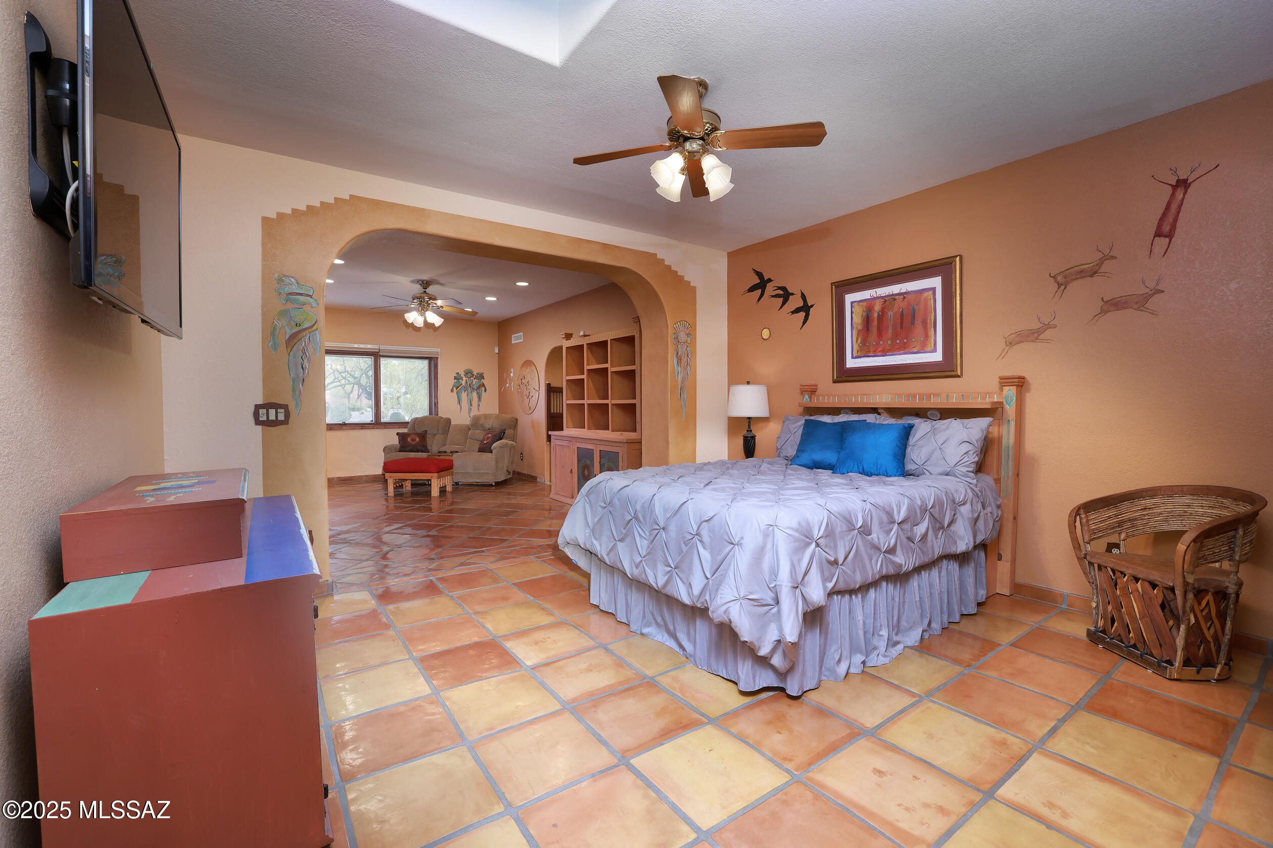925 North Rancho Del Jefe Loop Tucson, AZ 85748 - Photo 25 of 52 a spacious bedroom with a bed a chandelier and a dresser