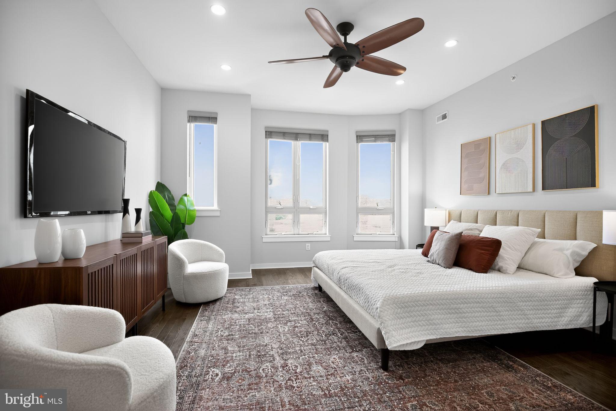 1711 South 20th Street Philadelphia, PA 19145 - Photo 18 of 36 a bedroom with a bed a couch and a flat screen television