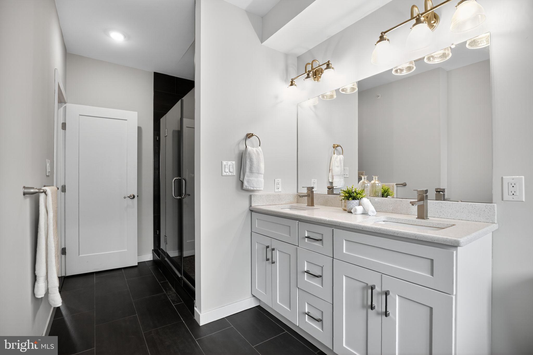 1711 South 20th Street Philadelphia, PA 19145 - Photo 20 of 36 a bathroom with a double vanity sink and a mirror