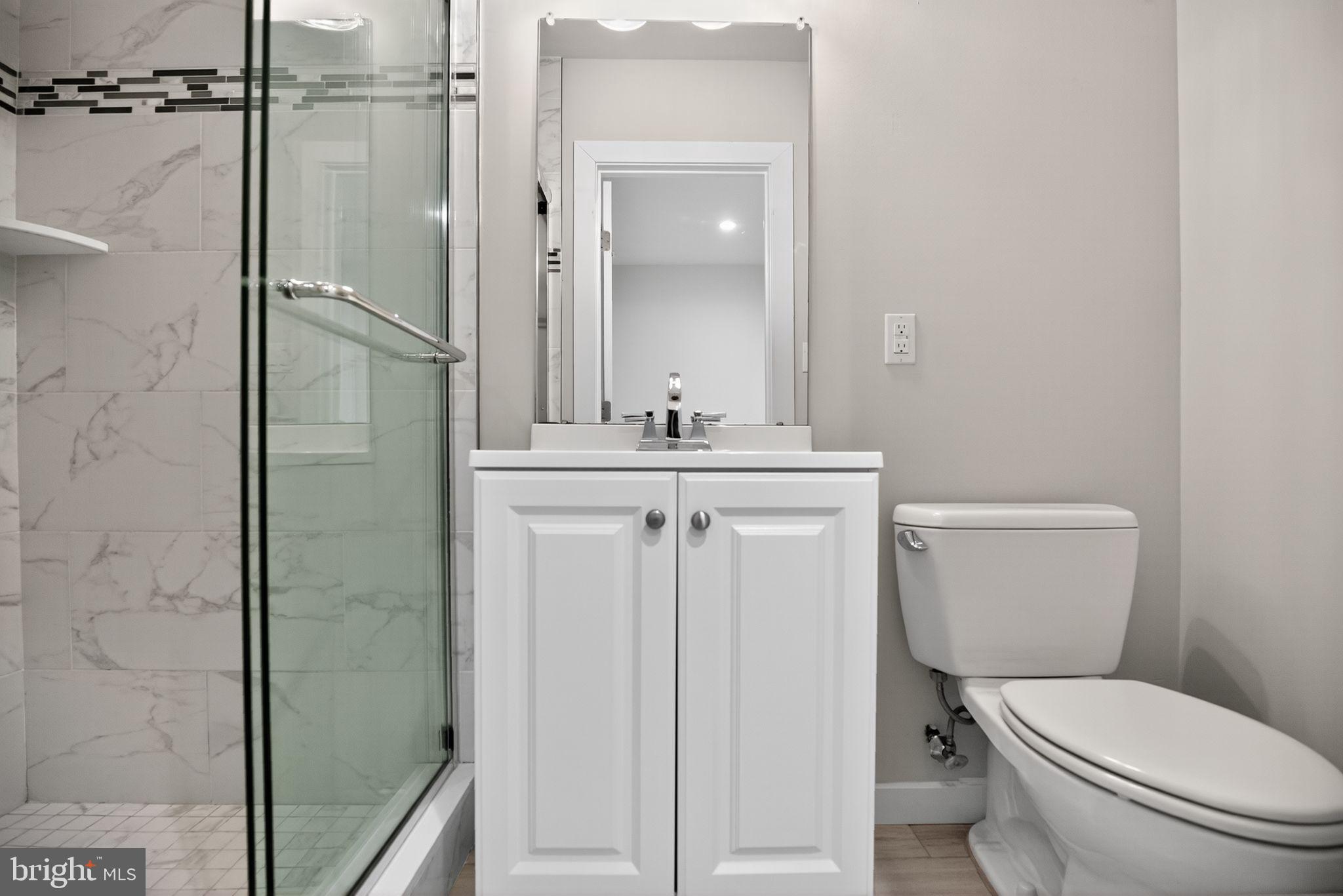 1711 South 20th Street Philadelphia, PA 19145 - Photo 28 of 36 a bathroom with a granite countertop toilet sink and shower