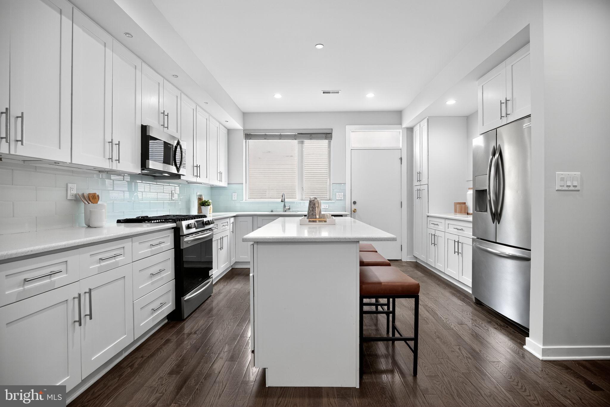 1711 South 20th Street Philadelphia, PA 19145 - Photo 7 of 36 a kitchen with a refrigerator a sink and a stove top oven