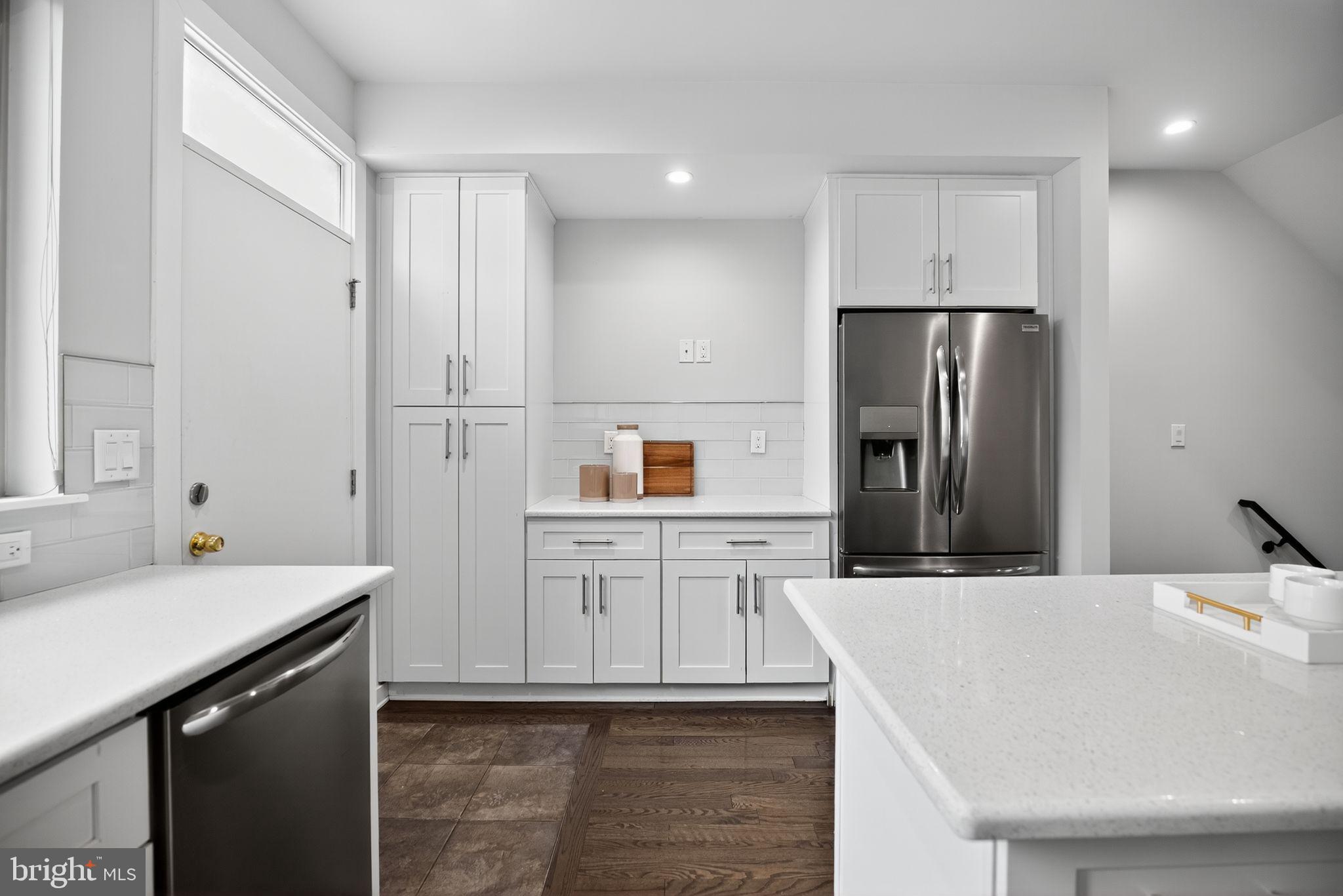 1711 South 20th Street Philadelphia, PA 19145 - Photo 9 of 36 a kitchen with stainless steel appliances kitchen island sink refrigerator and stove