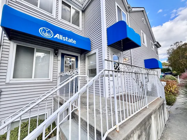 a view of a house with entrance and a balcony