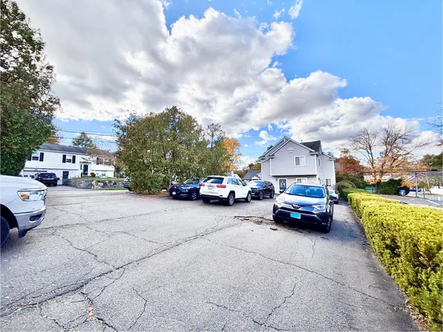a car parked in front of a house with cars