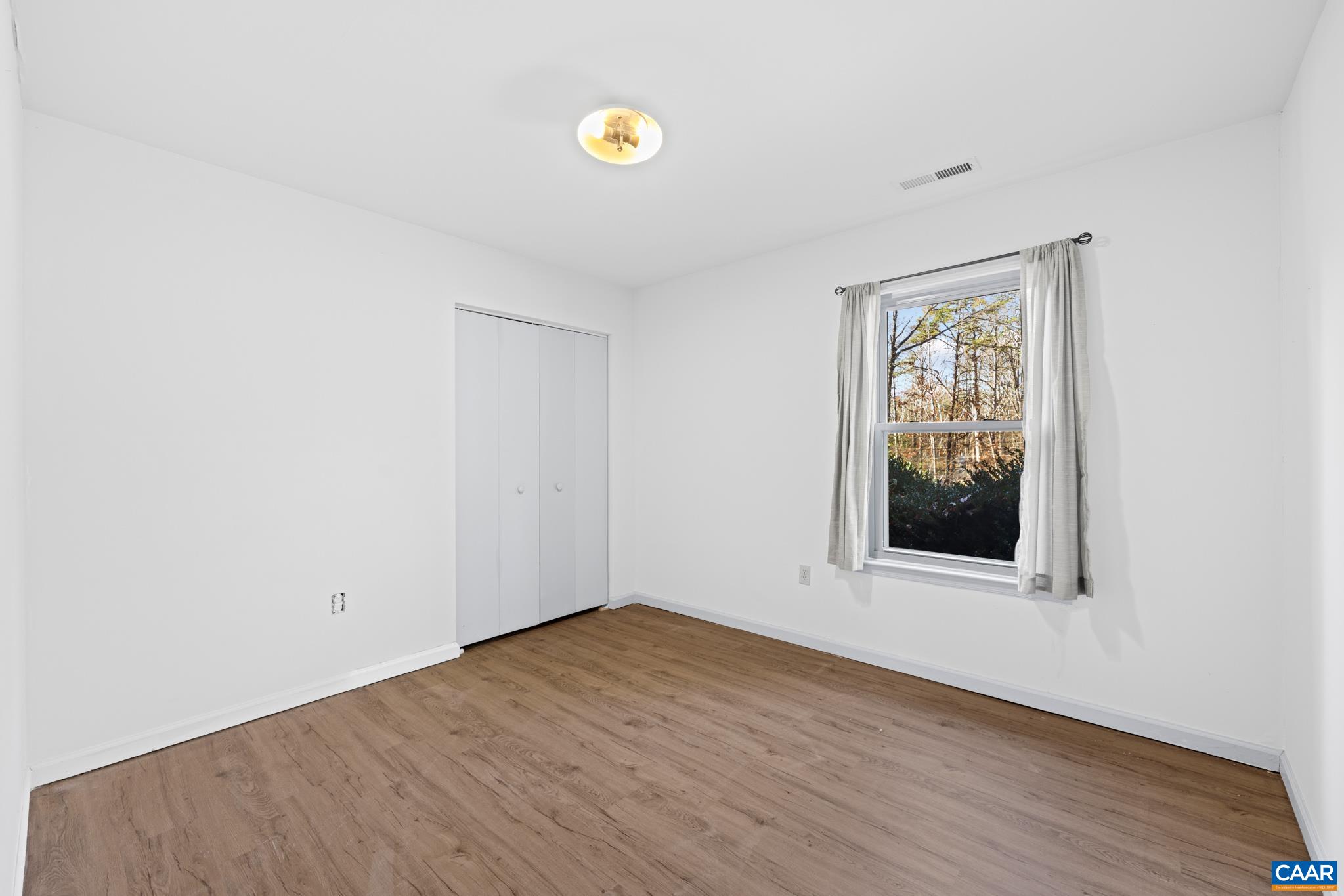 364 Larkspur Road Ruckersville, VA 22968 - Photo 16 of 29 a view of an empty room with wooden floor and a window