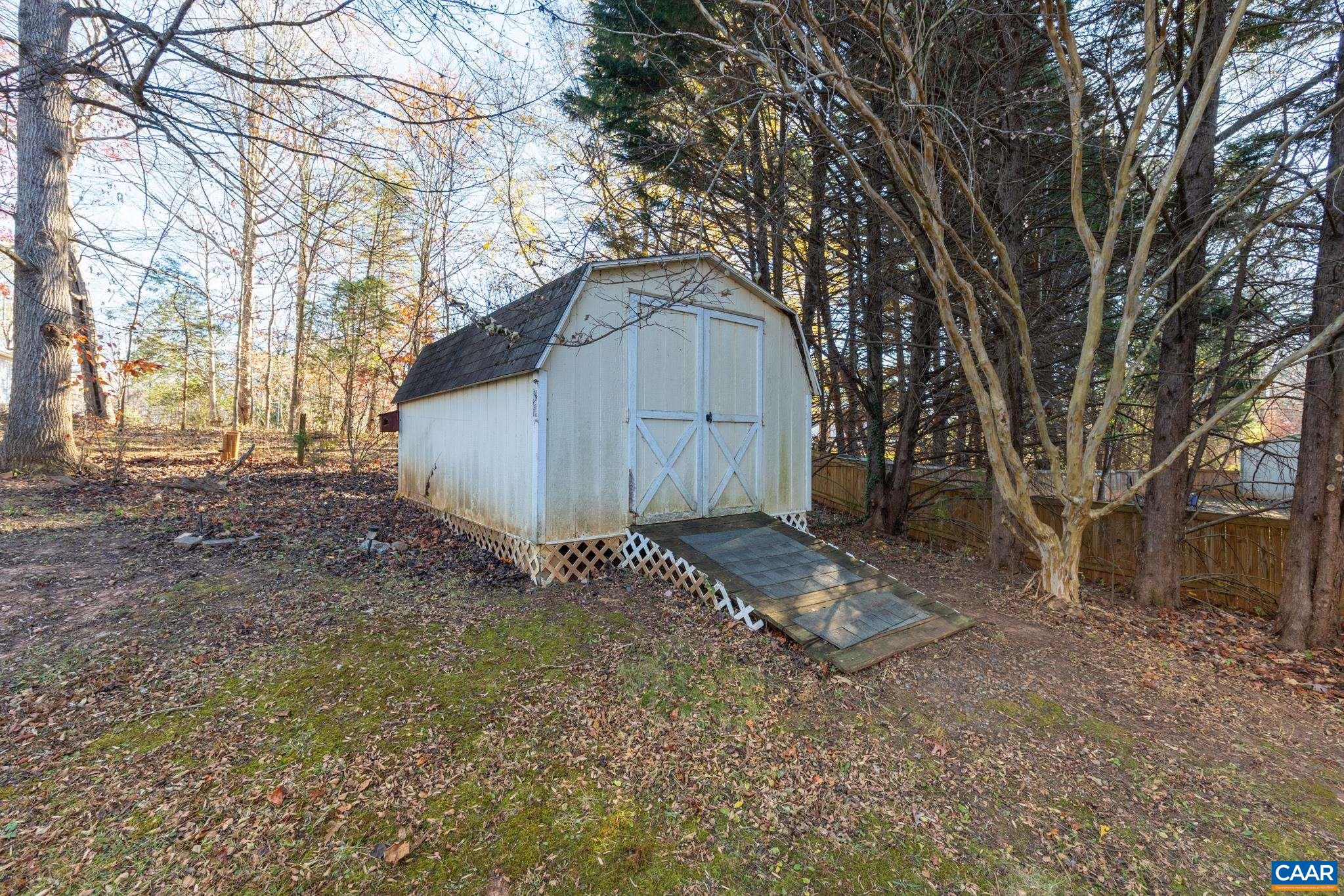 364 Larkspur Road Ruckersville, VA 22968 - Photo 29 of 29 a backyard of a house with wooden fence and large tree