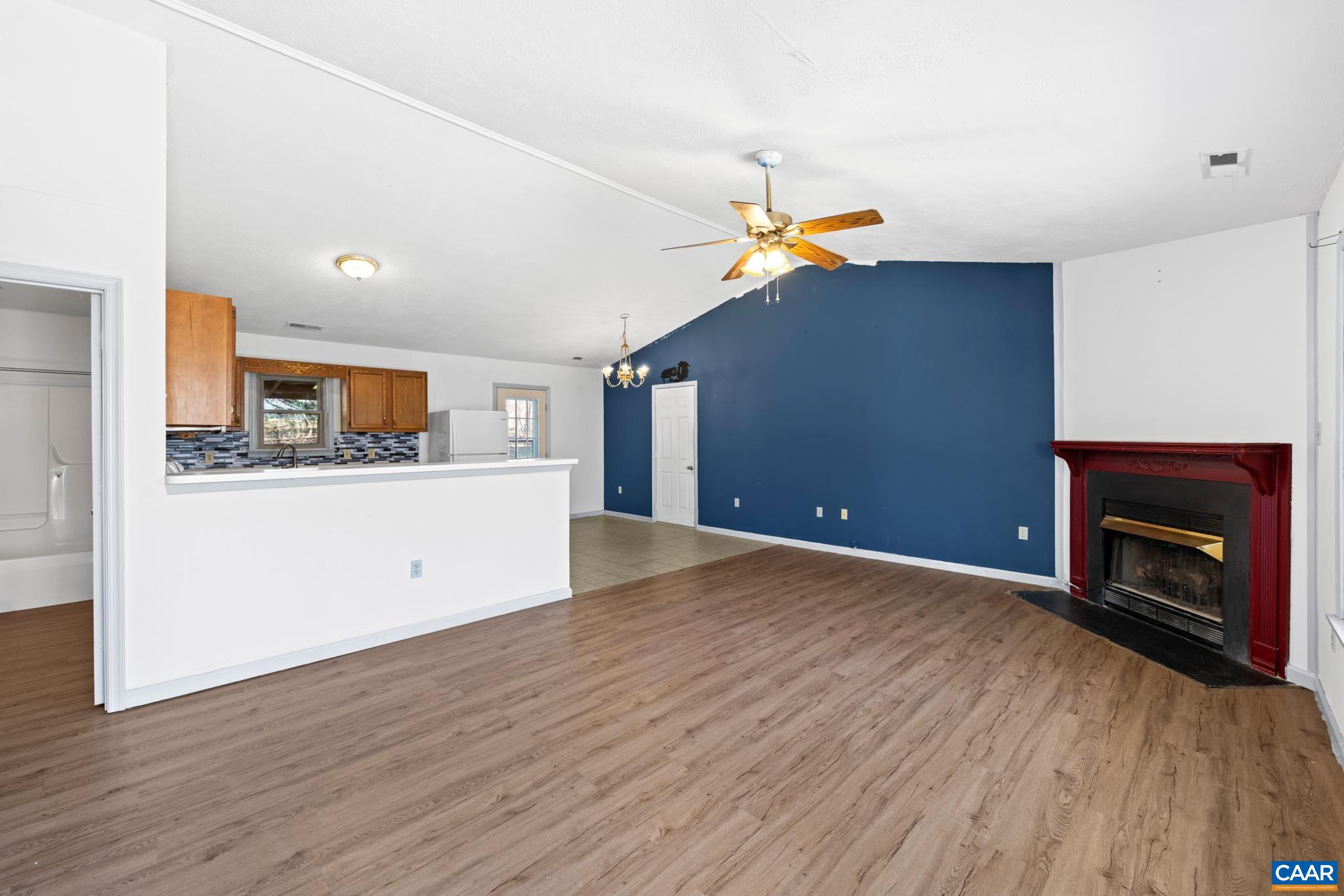 364 Larkspur Road Ruckersville, VA 22968 - Photo 6 of 29 a view of a kitchen with a sink and a fireplace