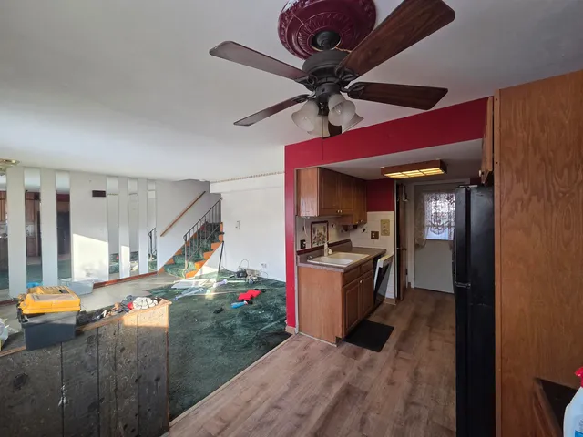 a kitchen with a sink a stove top oven a refrigerator and cabinets