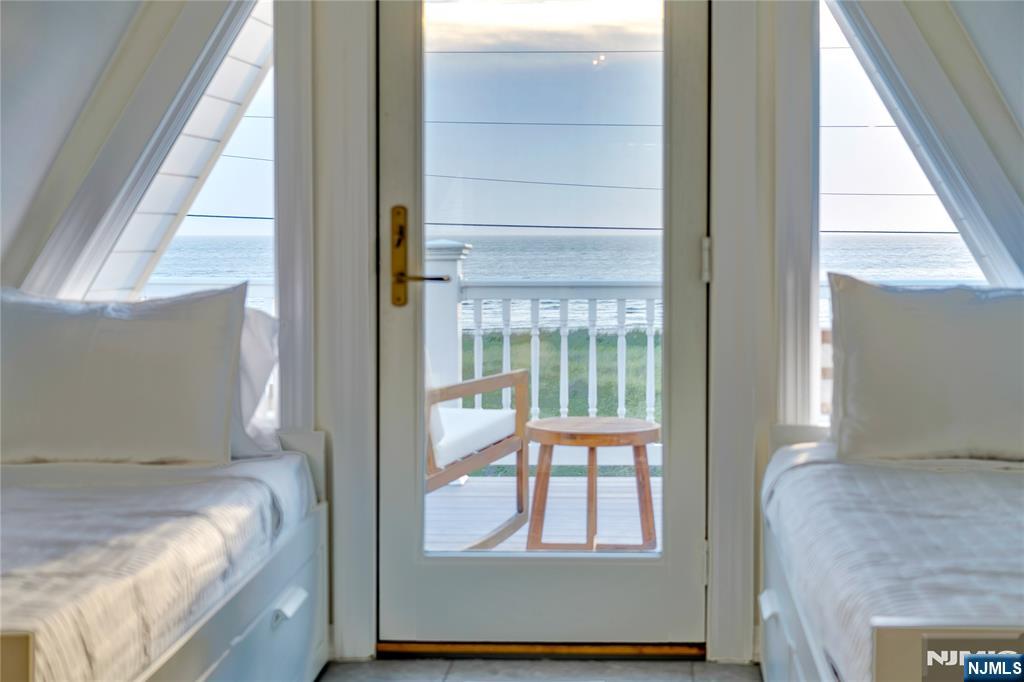 4006 Shore Road Villas, NJ 08251 - Photo 28 of 30 a bedroom with a bed and balcony