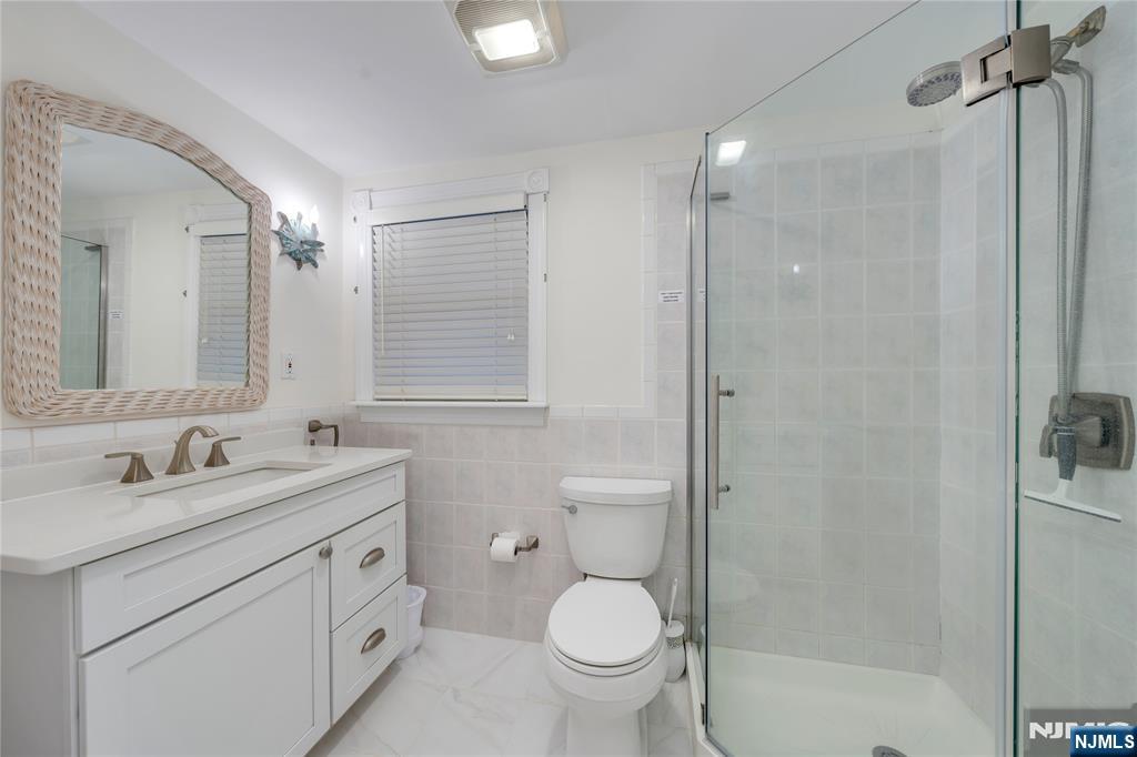 4006 Shore Road Villas, NJ 08251 - Photo 30 of 30 a bathroom with a toilet sink shower and mirror
