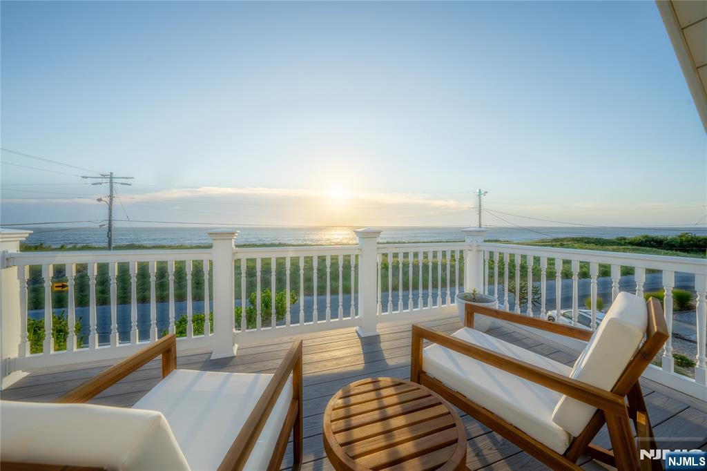 4006 Shore Road Villas, NJ 08251 - Photo 4 of 30 a balcony with wooden floor table and chairs
