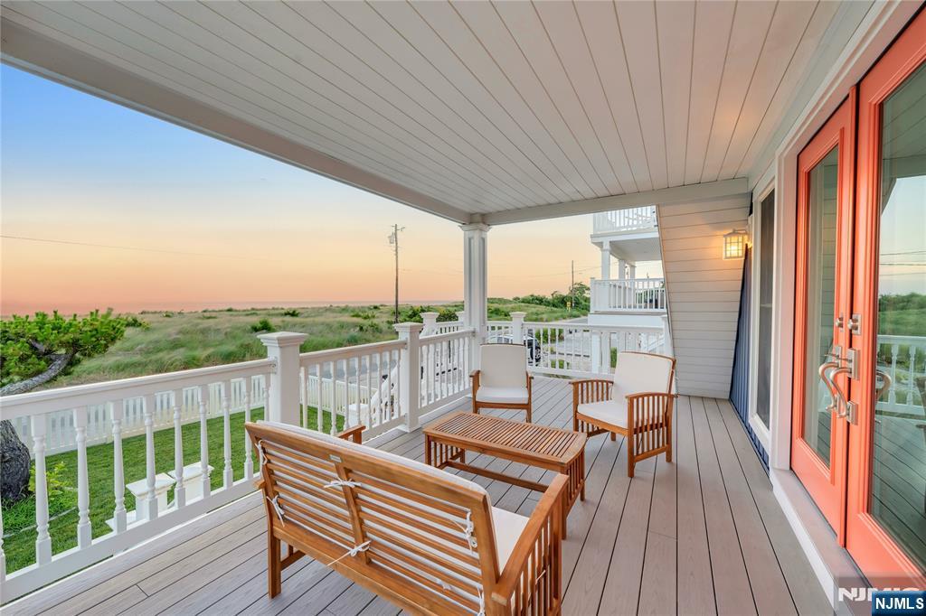 4006 Shore Road Villas, NJ 08251 - Photo 7 of 30 a balcony with furniture and wooden floor