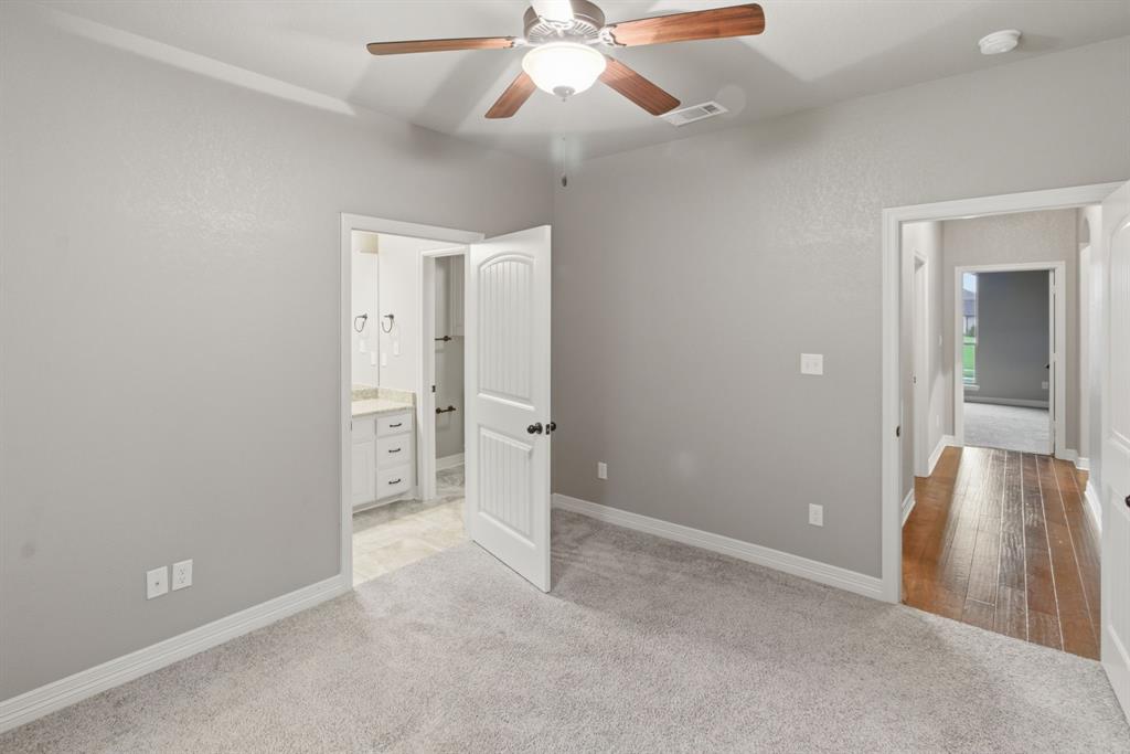 7765 Hickory Spring Lane Tyler, TX 75703 - Photo 31 of 38 Carpeted room with a ceiling fan featuring wood-finish blades, light gray walls, and white trim