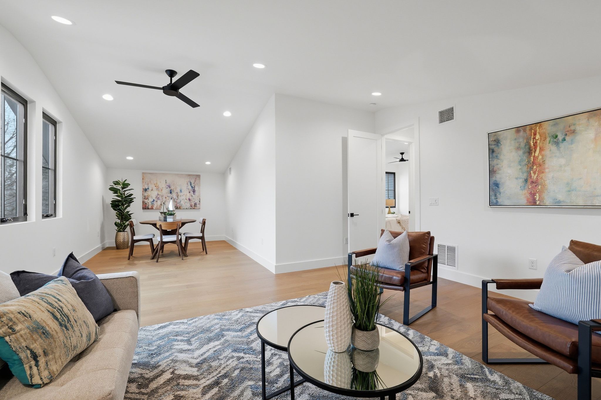 6611 Lexington Road Austin, TX 78757 - Photo 28 of 37 Open-concept living space with light wood-finish flooring, recessed lighting, and a contemporary ceiling fan