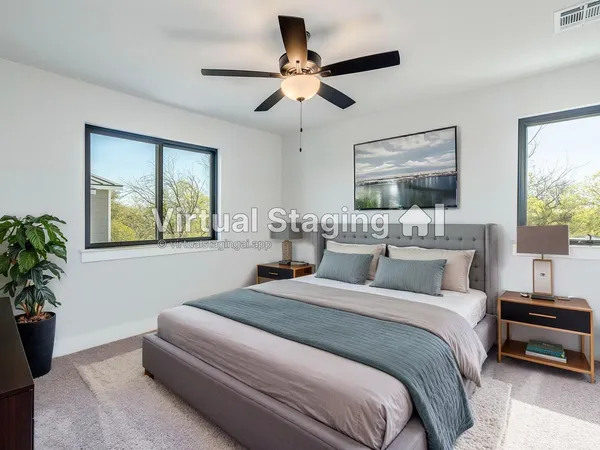 a bedroom with a bed and a painting on the wall