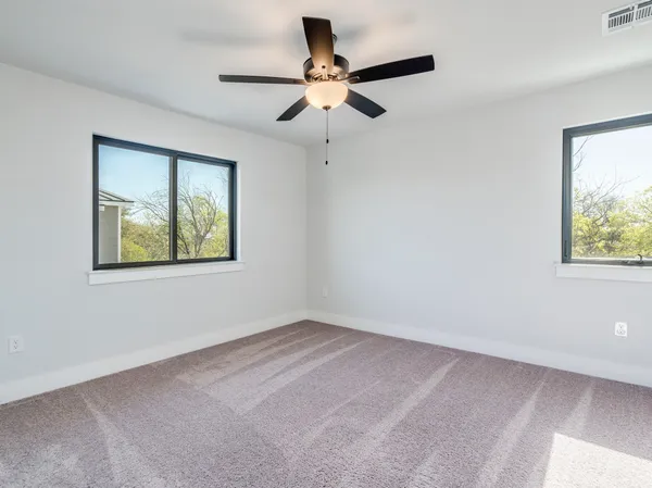 a bedroom with a large bed and a flat tv screen