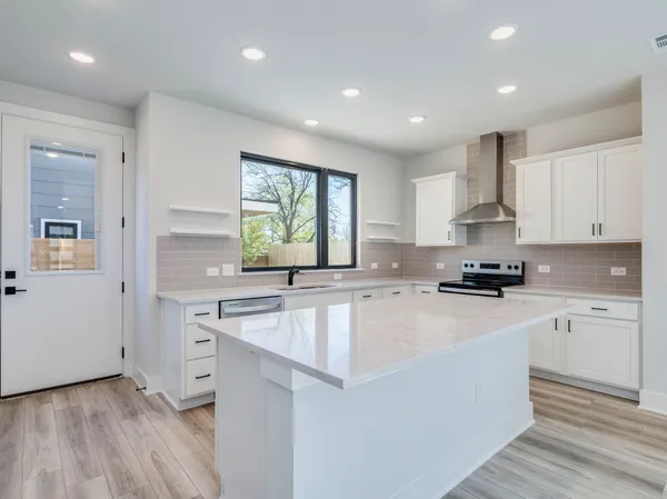 a large kitchen with a stove top oven