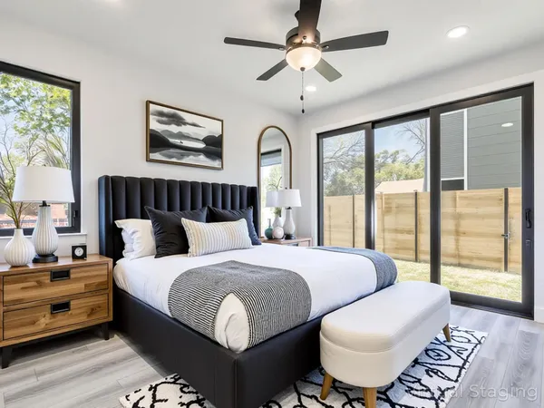 a bedroom with a bed and a large window