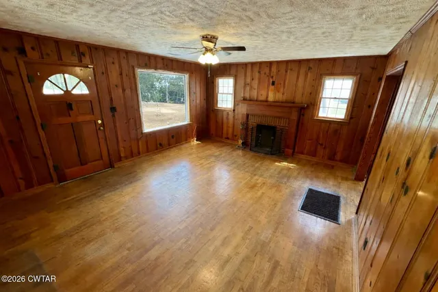 wooden floor in an empty room with a fireplace