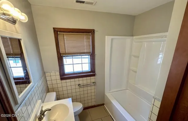 a bathroom with sink bathtub and shower